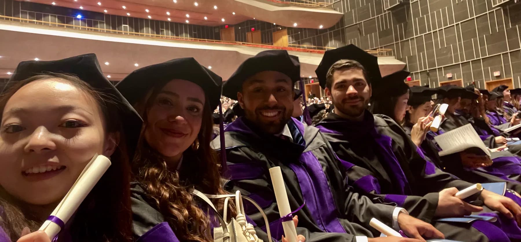 Law degree conferral ceremony: doctoral gowns with purple velvet hoods, the academic colour of the faculty of law.
